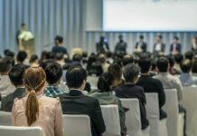 Audience listening to a panel discussion in a conference hall