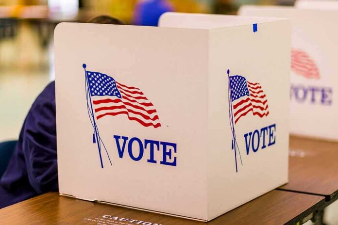 shutterstock_1046168668 voting booth with American flag graphics
