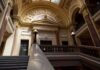 Epstein-Linked Death Reignites Troubling Questions Grand courthouse interior with domed ceiling and staircase