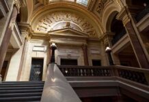 Grand courthouse interior with domed ceiling and staircase