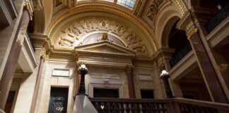Grand courthouse interior with domed ceiling and staircase