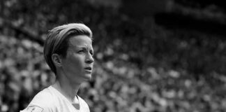 soccer player in jersey looks ahead during match