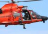 Rescue helicopter with crew performing hoist operation