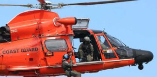 Rescue helicopter with crew performing hoist operation