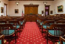 Courtroom with wooden benches facing the judge's bench