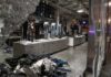 clothing store interior with broken glass and scattered garments