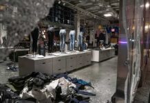 Police and Retailers Unite Against Shoplifters clothing store interior with broken glass and scattered garments