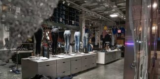 clothing store interior with broken glass and scattered garments