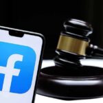 Smartphone with Facebook app logo beside a judge’s gavel