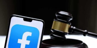 Smartphone with Facebook app logo beside a judge’s gavel