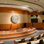 Democrats Plan Sweeping Trump Investigations Interior view of a government chamber with wooden paneling and seating