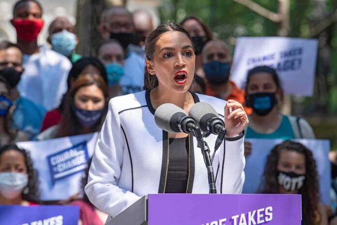 Woman speaking at outdoor rally behind microphones