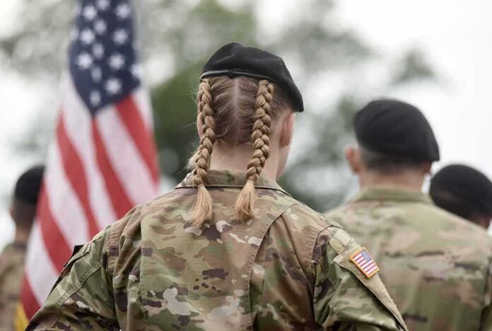 shutterstock_2038666382 soldier in camouflage with braided hair and beret