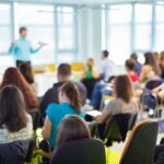 Audience in a classroom listening to a presenter