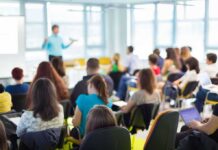 Audience in a classroom listening to a presenter