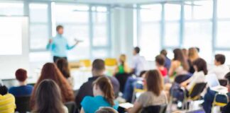 Audience in a classroom listening to a presenter