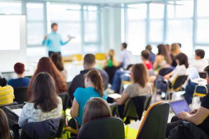 Audience in a classroom listening to a presenter