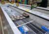 Global Food Shock Warning: The Buffer Is Running Dry supermarket freezer with mostly empty shelves and a few meat packages