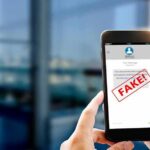 Impostor Message Triggers Security Alert Hands holding smartphone showing scam text marked fake