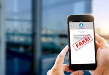 Hands holding smartphone showing scam text marked fake