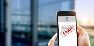 Hands holding smartphone showing scam text marked fake