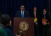 Man at podium during press conference