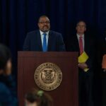 Man at podium during press conference