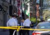 Police officers and investigators at a taped-off city street scene