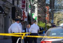 Old Domestic Arrest Resurfaces After WNBA Remarks Police officers and investigators at a taped-off city street scene