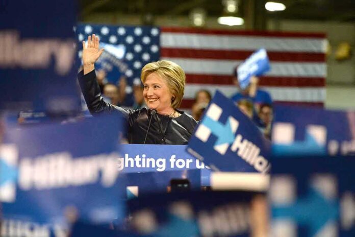 woman waving at a rally podium