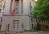 DOJ Probes Claims of Anti-Trump Plot Stone government building with American flag at entrance