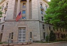 DOJ Probes Claims of Anti-Trump Plot Stone government building with American flag at entrance