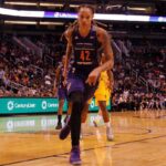 basketball player dribbling on a court during a game