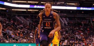 basketball player dribbling on a court during a game