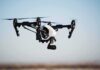 Drones Raise Fresh Alarm Across Europe Quadcopter drone with camera flying outdoors