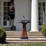 Podium with presidential seal in a garden colonnade