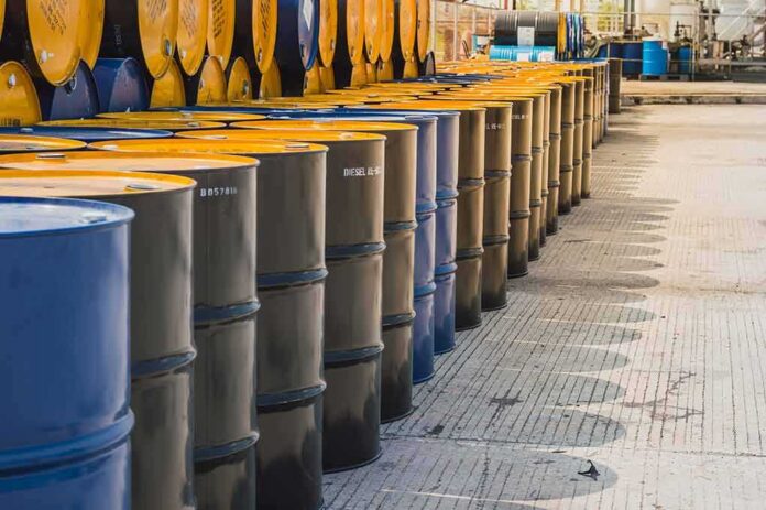 shutterstock_1082741726-1 Rows of industrial metal barrels with yellow lids