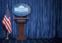 FBI Photos Show Classified Materials White House press briefing podium with U.S. flag and blue curtain