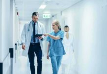 Ohio Hospital Faces Wrong-Site Surgery Lawsuit Doctor and nurse walking in a hospital corridor reviewing a tablet