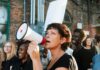 Activists Ejected as Congress Probes Foreign Influence Woman with megaphone speaking at a street protest
