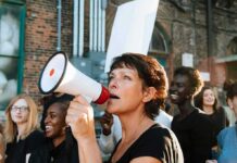 Activists Ejected as Congress Probes Foreign Influence Woman with megaphone speaking at a street protest