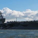 Aircraft carrier at sea with fighter jets on deck