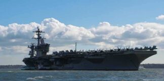 Aircraft carrier at sea with fighter jets on deck
