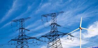 Power lines with wind turbine and solar panels