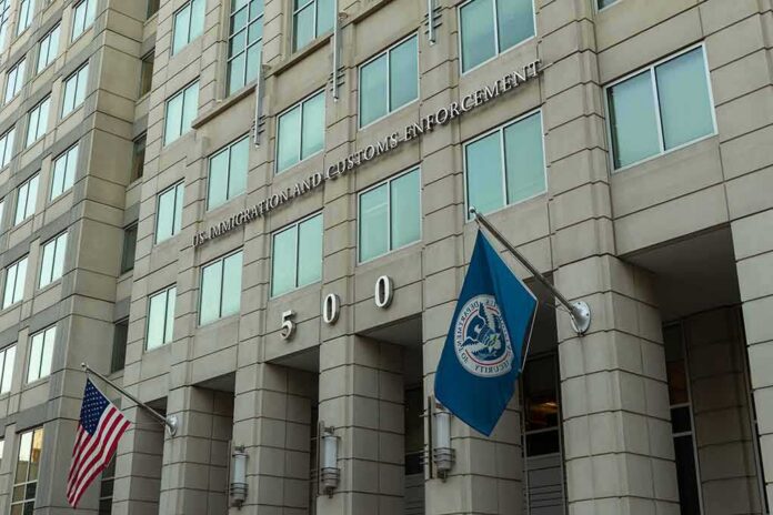 shutterstock_1485768215-1 U.S. government building facade with American and blue departmental flags