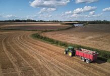 Viral: Cotton Fields Never Disappeared Tractor with red trailer on harvested field