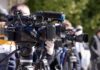 Video cameras on tripods at an outdoor press event