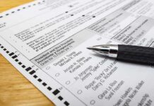 Iowa Poll Lawsuit Comes to an End Ballot paper with pen on wooden surface