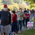Christian Jones and others waiting in a long line outside a polling place