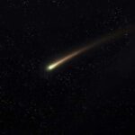 Comet streaking across a starry night sky